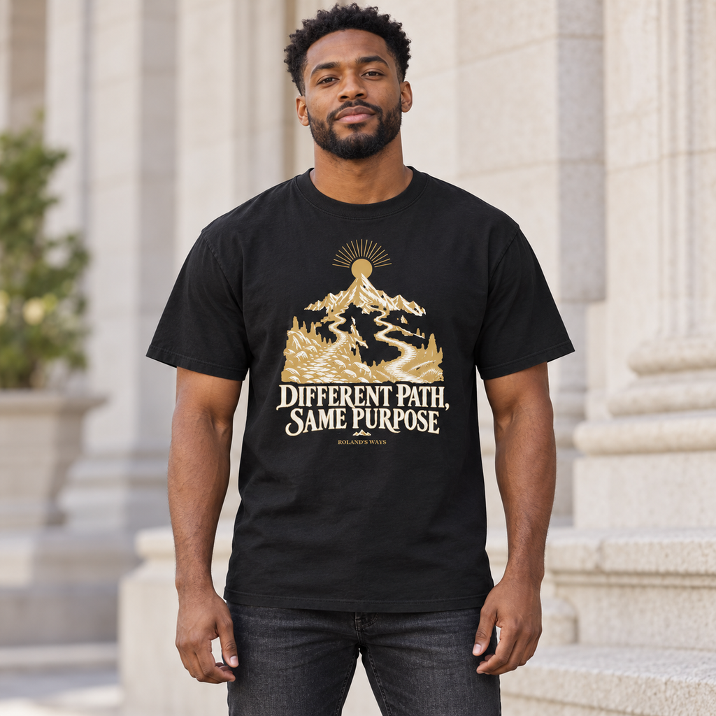 AI urban lifestyle mockup of a man wearing the black Different Path, Same Purpose T-shirt with gold and ivory mountain artwork.
