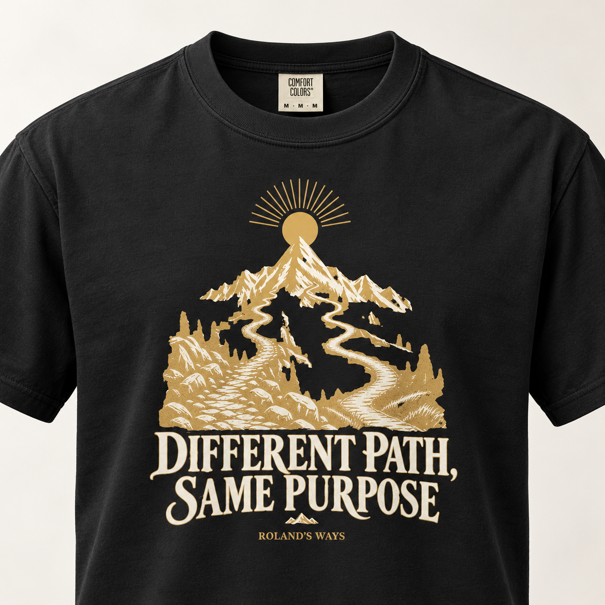 AI close-up mockup of the mountain artwork and slogan on the black Different Path, Same Purpose T-shirt with gold and ivory mountain artwork.