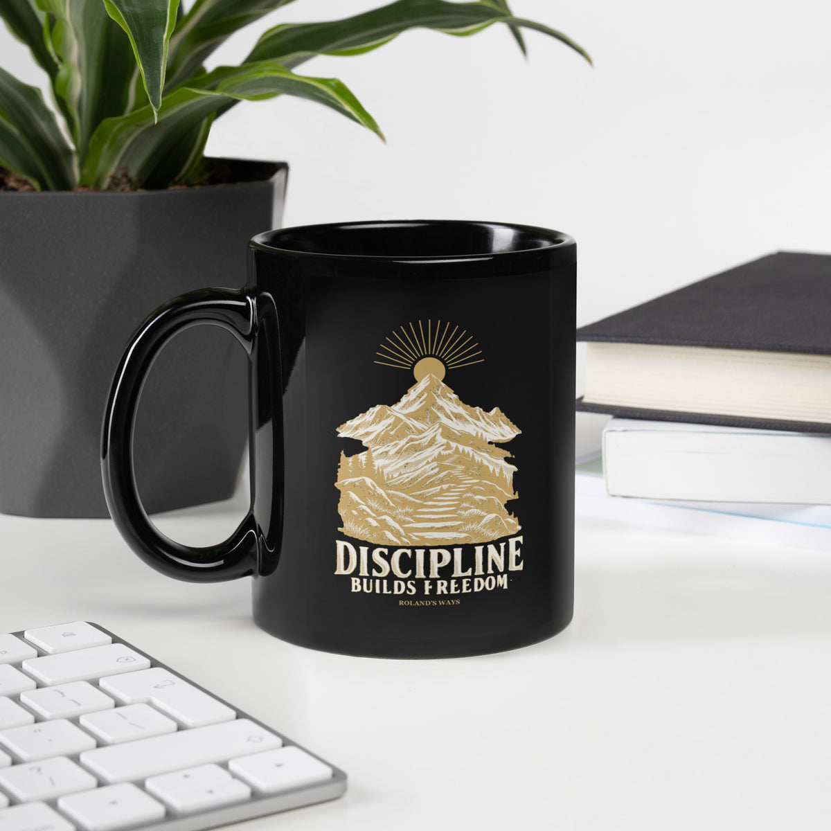 Discipline Builds Freedom Black Glossy Mug in black, with handle on the left with gold and ivory Journey artwork.