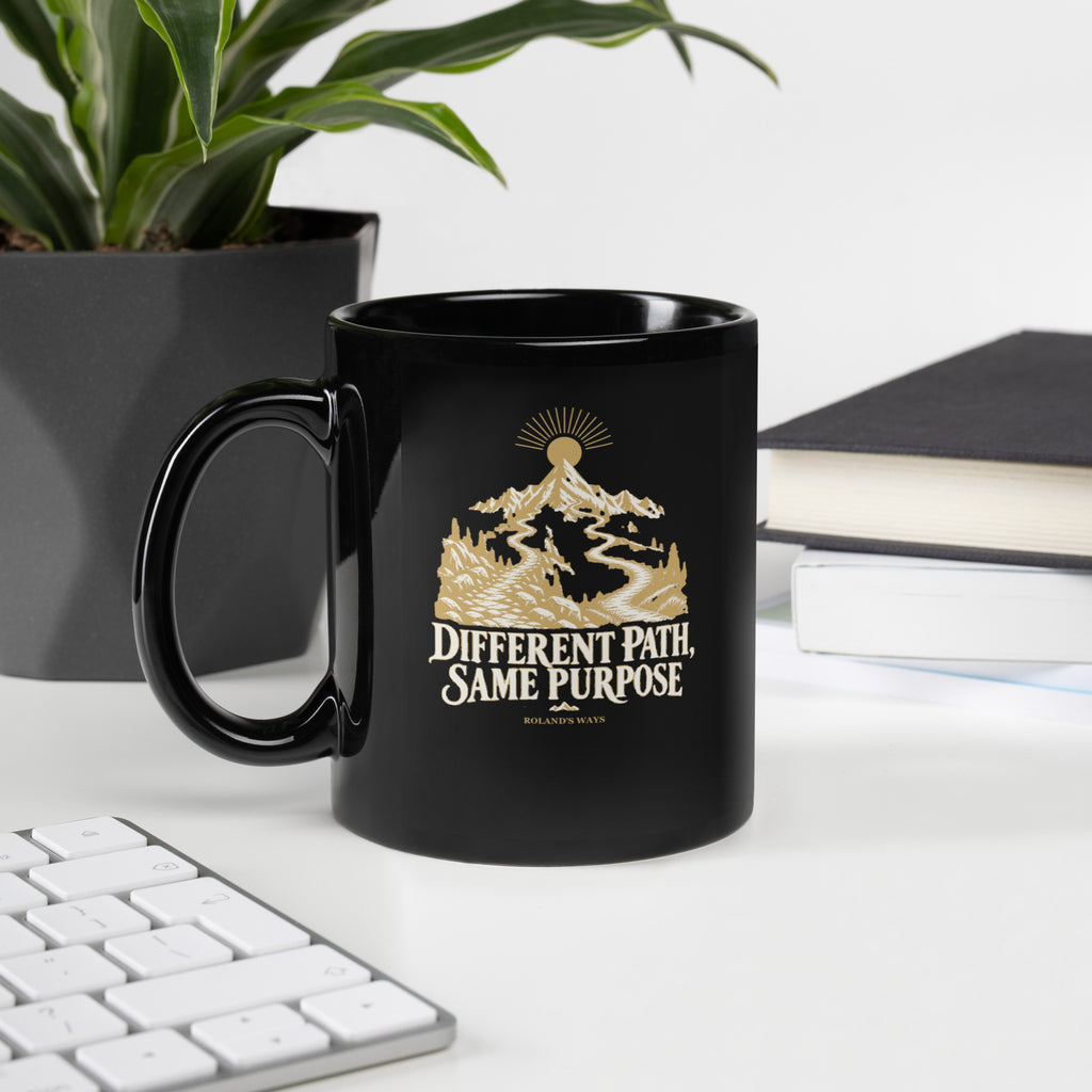 Different Path, Same Purpose Black Glossy Mug in black, with handle on the left with gold and ivory Journey artwork.
