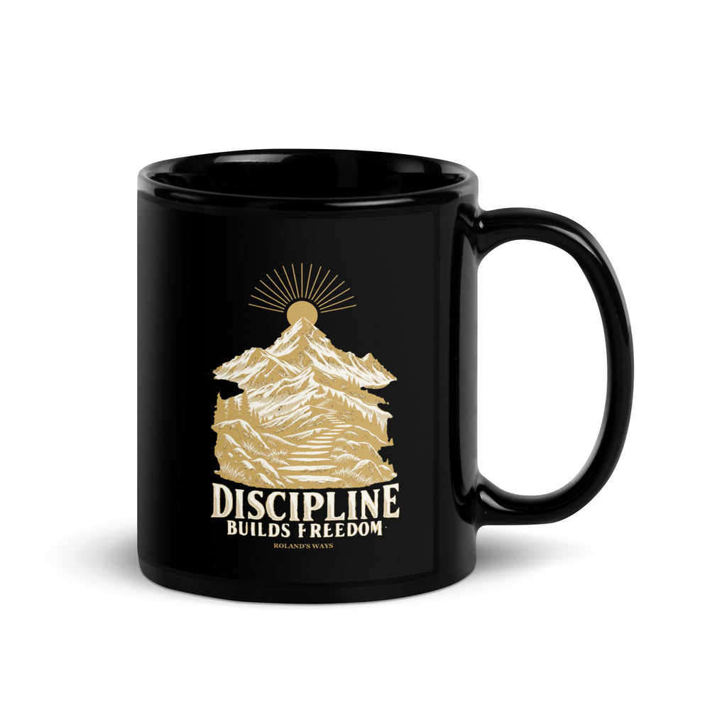 Discipline Builds Freedom Black Glossy Mug in black, with handle on the right with gold and ivory Journey artwork.