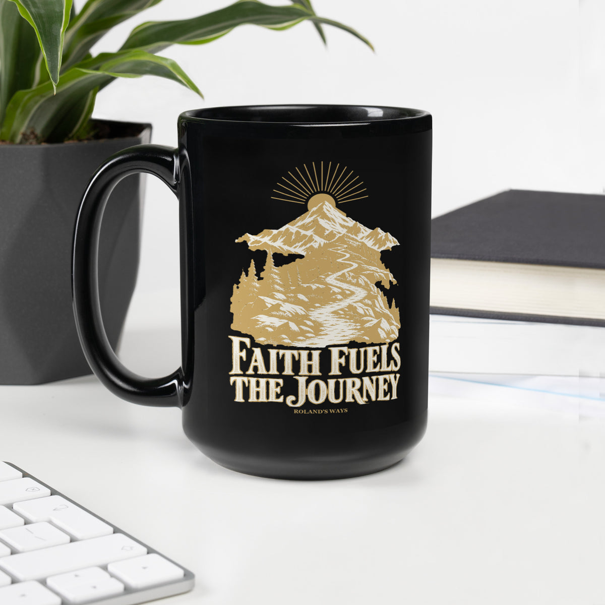Faith Fuels the Journey Black Glossy Mug in black, with handle on the left with gold and ivory Journey artwork.