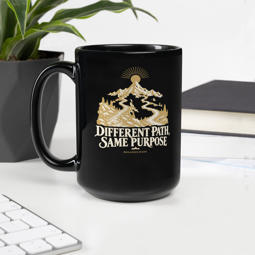 Different Path, Same Purpose Black Glossy Mug in black, with handle on the left with gold and ivory Journey artwork.