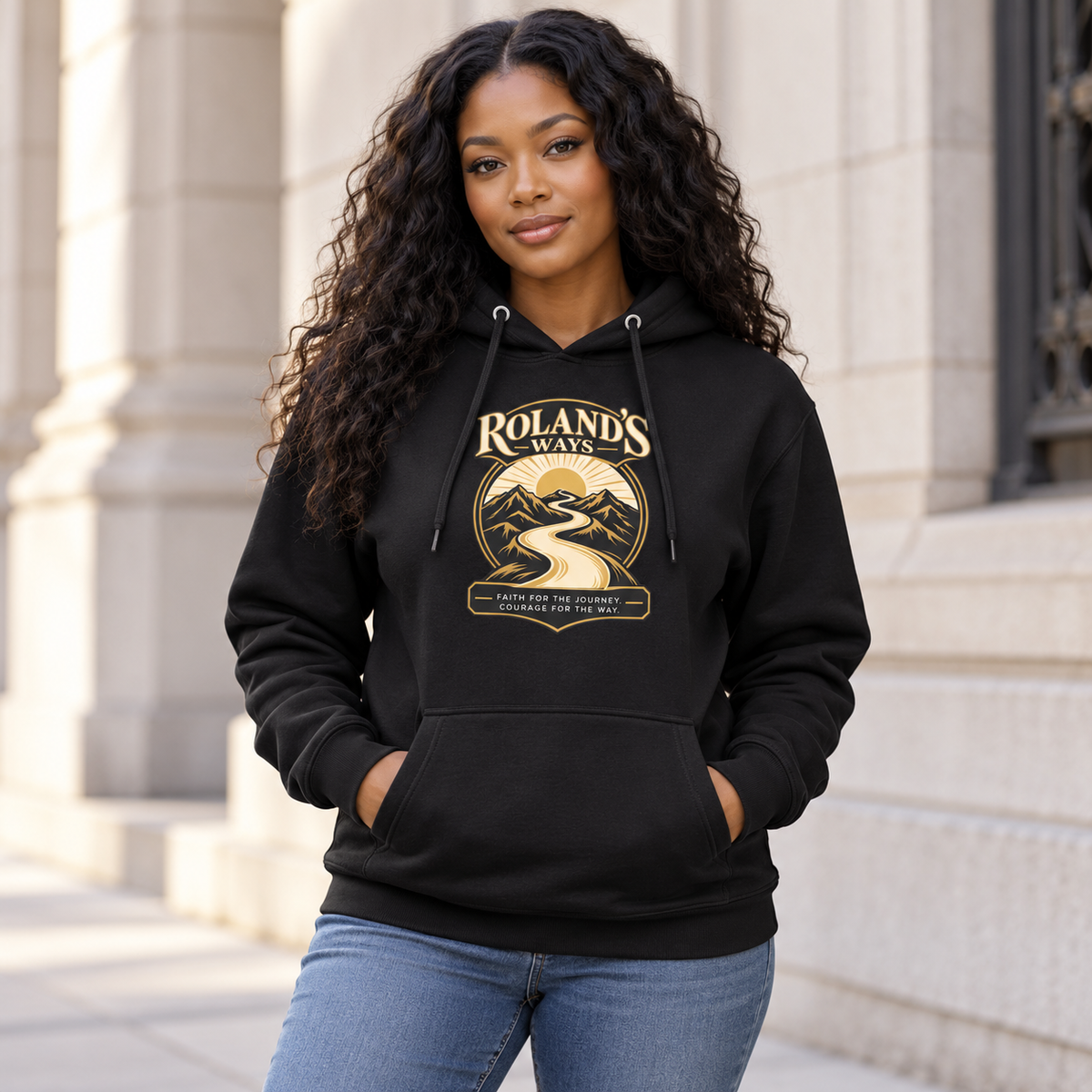 AI lifestyle mockup of a woman wearing the black Faith for the Journey Premium Hoodie beside pale stone architecture.