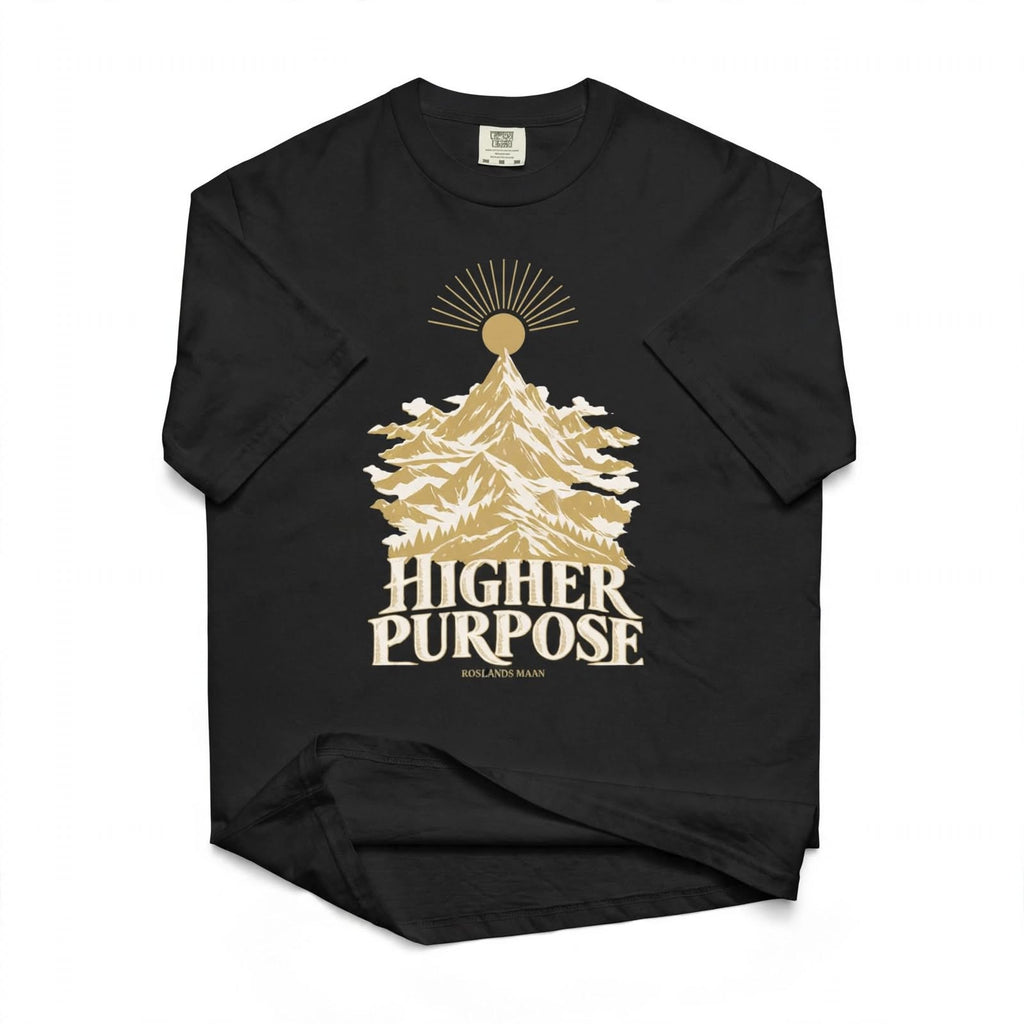 AI styled flat-lay mockup of the black Higher Purpose T-shirt with gold and ivory mountain artwork.