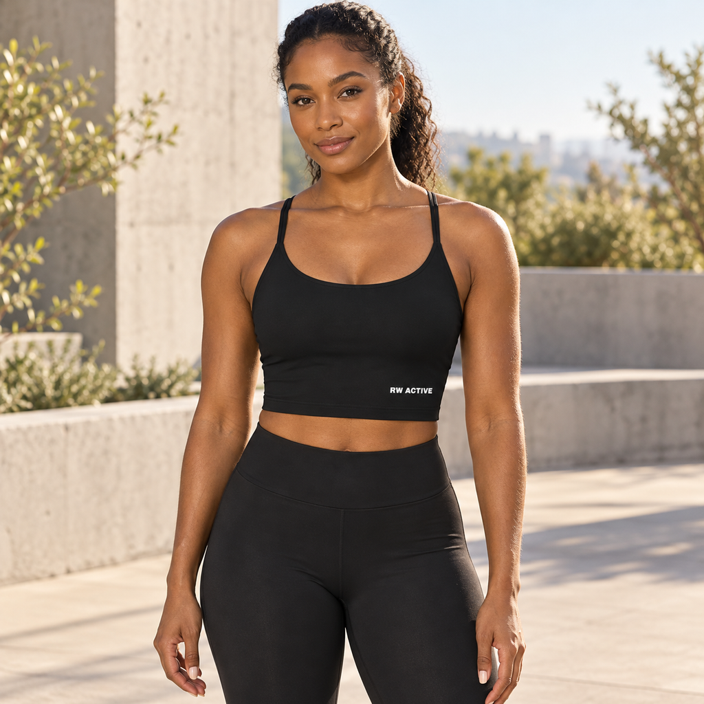 Illustrative lifestyle mockup of a woman wearing the black RW ACTIVE longline sports bra.