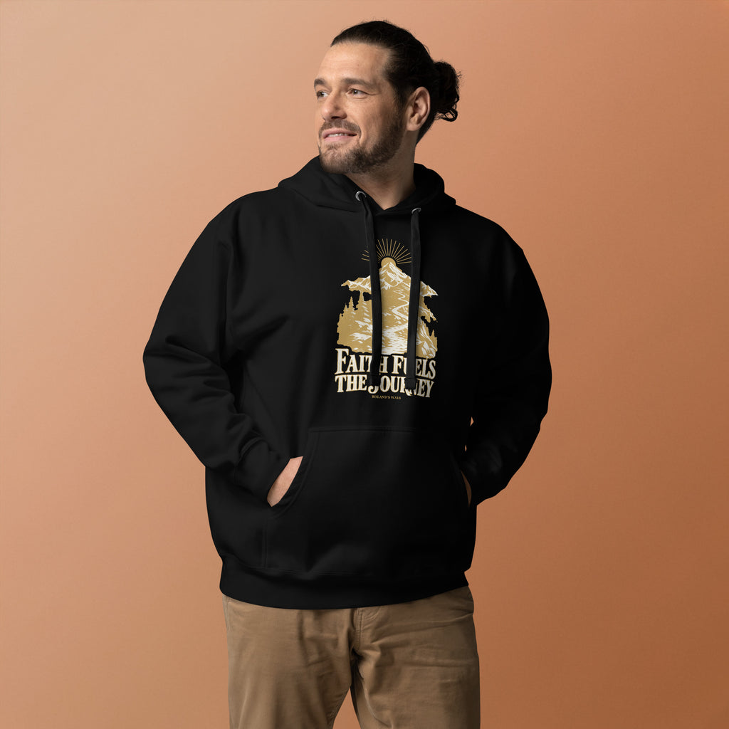 Faith Fuels the Journey Premium Hoodie in black, front view with gold and ivory Journey artwork.