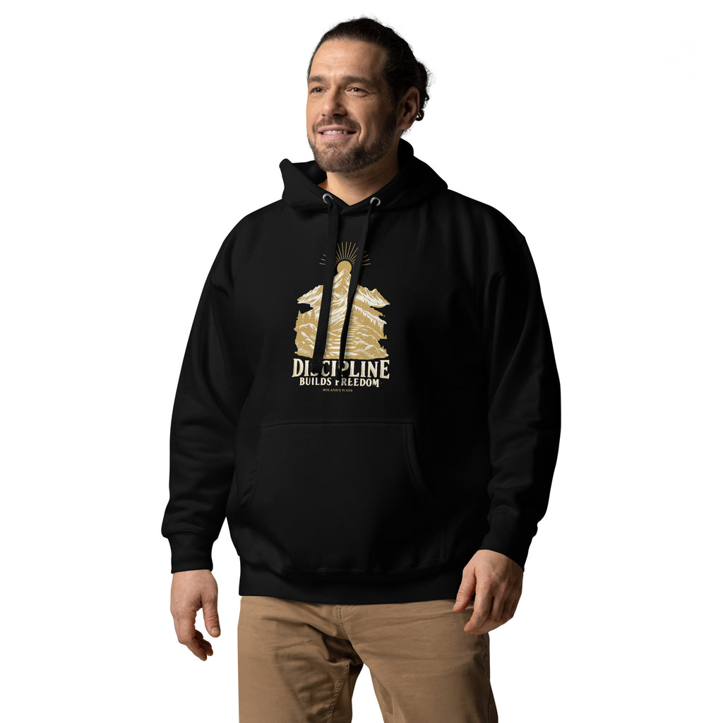Discipline Builds Freedom Premium Hoodie in black, from a front-left angle with gold and ivory Journey artwork.